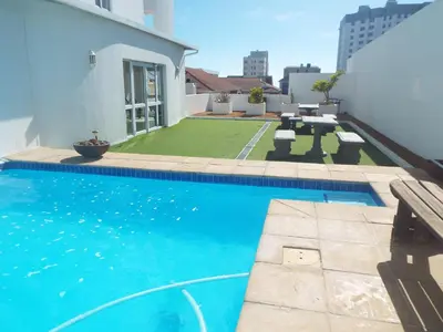 a swimming pool in the backyard of a house at Palmsbeach 3 in Strand