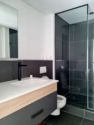 a bathroom with a sink and a glass shower at Bridgewater One by Smart City Stays in Cape Town