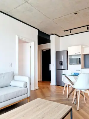 a living room with a couch and a table at Bridgewater One by Smart City Stays in Cape Town