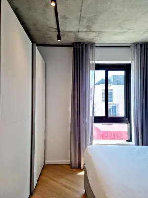 a bedroom with a bed and a large window at Bridgewater One by Smart City Stays in Cape Town