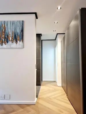 a hallway with white walls and a painting on a wall at Bridgewater One by Smart City Stays in Cape Town
