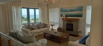 a living room with a couch and a fireplace at Knight's House in Hermanus