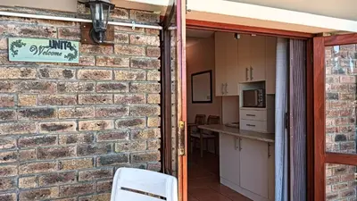 a brick wall with a door leading into a kitchen at Plattekloof Treasures in Cape Town