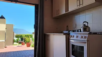 a kitchen with a tea kettle on top of a stove at Plattekloof Treasures in Cape Town