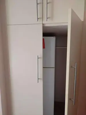 a kitchen with a white refrigerator and cabinets at Plattekloof Treasures in Cape Town