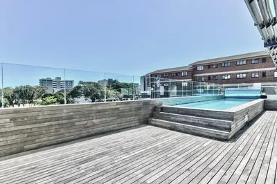 a swimming pool on the roof of a building at Sea and Sun-Table Mountain views Wifi Parking! in Cape Town
