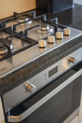 a stove top oven with a bunch of knobs on it at Sea and Sun-Table Mountain views Wifi Parking! in Cape Town