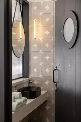 a bathroom with a sink and a mirror at Hornbill House Self Catering Accommodation in Hermanus