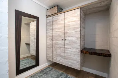 a dressing room with a mirror and a closet at Hornbill House Self Catering Accommodation in Hermanus