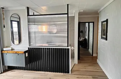 a kitchen with a counter and a sink in a room at Hornbill House Self Catering Accommodation in Hermanus