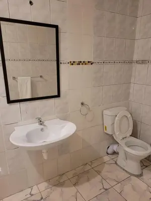 a bathroom with a sink and a toilet and a mirror at Jacmo Guest Private Rooms in Cape Town
