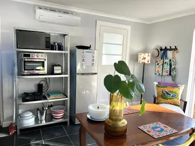 a kitchen with a table and a refrigerator at Spacious Stays Apartment in Paarl