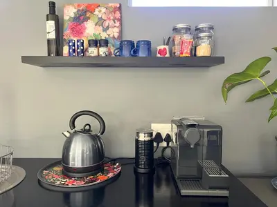 a kitchen counter with a tea kettle and a coffee maker at Spacious Stays Apartment in Paarl