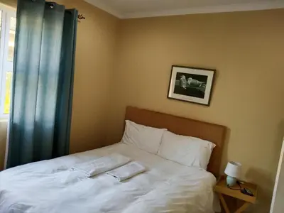 a bedroom with a bed with two towels on it at On the Wrench in Cape Town