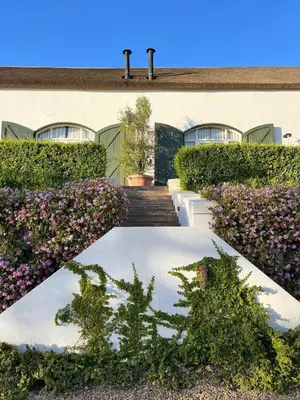 a garden with flowers in front of a building at Penhill Farm West Grange in Nuy