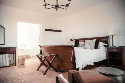 a bedroom with a bed and a chair and a window at Penhill Farm West Grange in Nuy