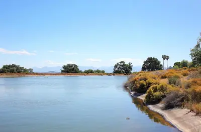 a river in the middle of a field at Penhill Farm Peppertree Cottage in Nuy