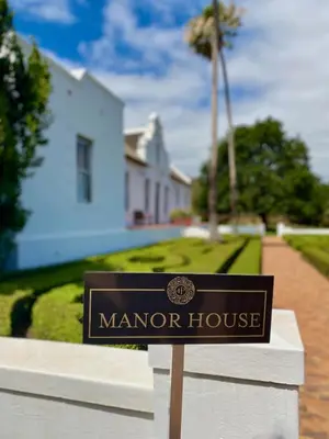 a sign for a manor house in front of a house at Penhill Farm The Manor House in Nuy