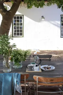 a wooden table with a plate of food on it at Penhill Farm The Manor House in Nuy