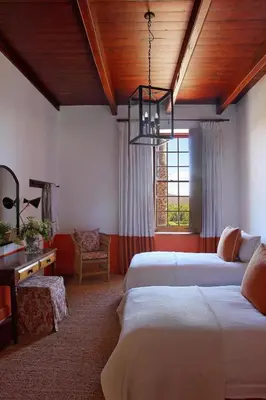 a bedroom with two beds and a chandelier at Penhill Farm The Manor House in Nuy