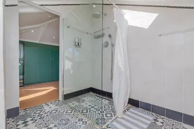 a shower with a glass door in a bathroom at Casa Lucia in Cape Town