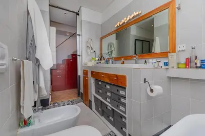 a bathroom with a sink toilet and a mirror at Casa Lucia in Cape Town