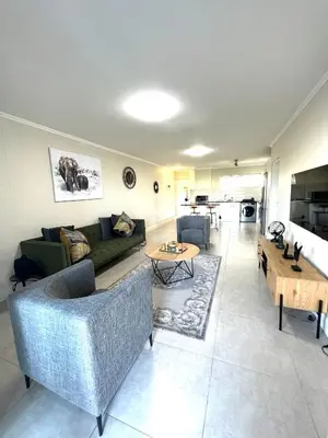 a living room with a couch and a table at Ashton Park 221 in Cape Town