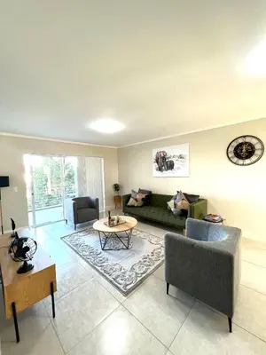 a living room with a couch and a table at Ashton Park 221 in Cape Town