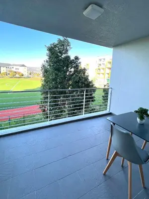 a room with a large window with a view of a tennis court at Ashton Park 221 in Cape Town