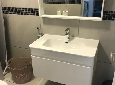 a bathroom with a white sink and a mirror at MLMK Property Studio17 in Cape Town