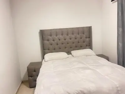 a bed with two pillows on it in a room at Eden Heights in Cape Town