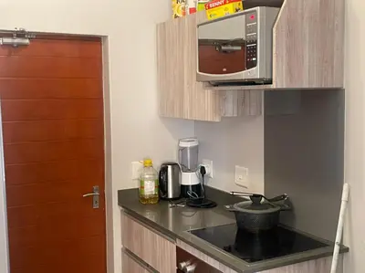 a kitchen with a counter top with a microwave at Eden Heights in Cape Town