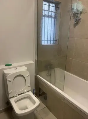 a bathroom with a toilet and a shower at Eden Heights in Cape Town