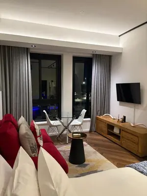 a living room with a couch and a flat screen tv at Bridgewater one luxury Apartment in Cape Town