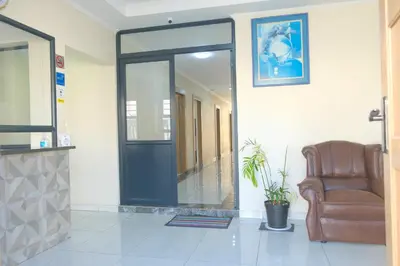 a waiting room with a chair and a mirror at Supa Guesthouse in Parow