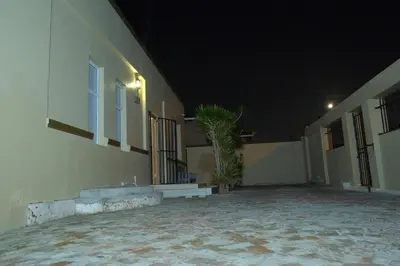 an empty courtyard of a building at night at Supa Guesthouse in Parow