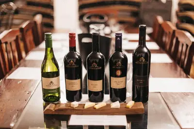 four bottles of wine sitting on a table at Mitre's Edge Vineyard Studio in Klapmuts