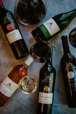 a group of bottles of wine on a table at Mitre's Edge Vineyard Studio in Klapmuts