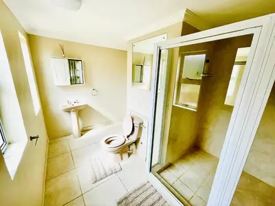 a bathroom with a toilet and a shower at Hotel Vibes Cape Town Plattekloof in Cape Town