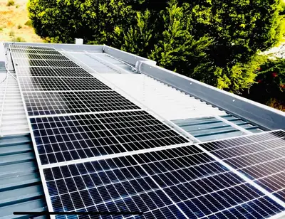 a group of solar panels on top of a roof at Hotel Vibes Cape Town Plattekloof in Cape Town