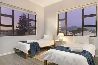 a bedroom with two beds and two windows at Jacquelena Hof 9 in Strand