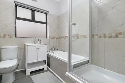 a bathroom with a toilet and a tub and a shower at Jacquelena Hof 9 in Strand