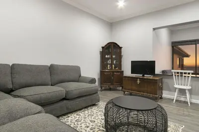 a living room with a couch and a tv at Jacquelena Hof 9 in Strand