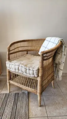 a wicker chair with a cushion on top of it at Villa Nordica - 2 bedroom self-catering apartment in Cape Town