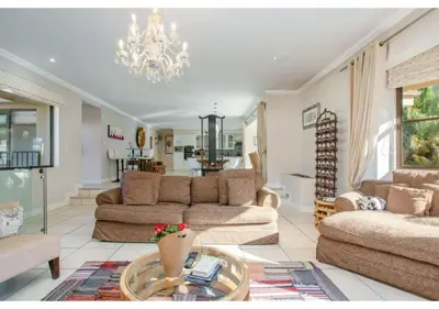 a living room with two couches and a chandelier at Florin’s Crest 3 Bedroom Villa, Franschhoek in Franschhoek