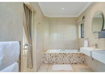 a bathroom with a tub and a sink at Florin’s Crest 3 Bedroom Villa, Franschhoek in Franschhoek