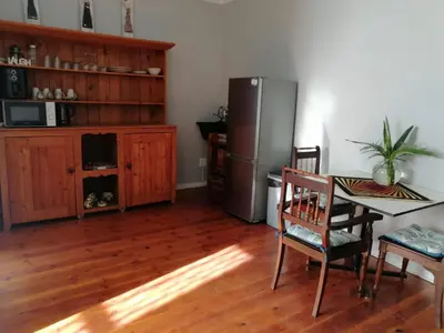 a kitchen with a refrigerator and a table and chairs at Die Tuis Huis Selfcatering NO LOADSHEDDING in Worcester