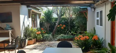 a patio with a table and chairs and plants at Die Tuis Huis Selfcatering NO LOADSHEDDING in Worcester