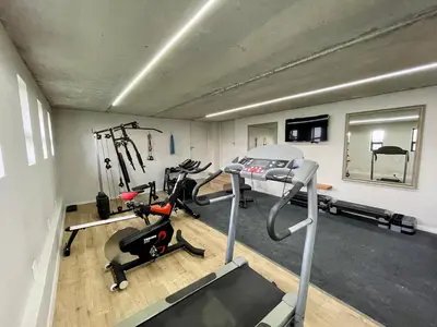 a gym with two treadmills and a treadmill at Escape to Pringle in Pringle Bay