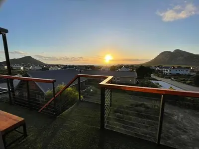 a view of the sunset from the balcony of a house at Escape to Pringle in Pringle Bay